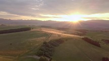 Golden sunset over mountains silhouette and rural nature landscape Aerial view
