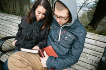mother and son reading a Bible together and praying together 