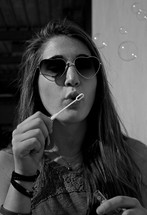 young woman blowing bubbles 