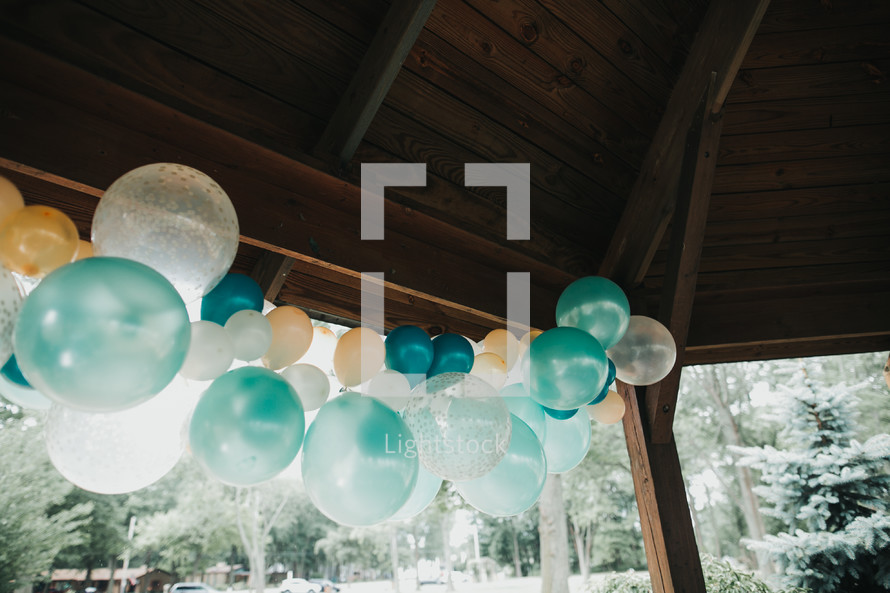 party balloons on a covered picnic area 