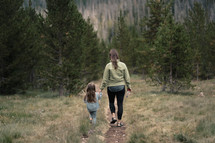 mother and daughter walking on a trail 