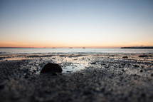 receding tide at sunset from ground view