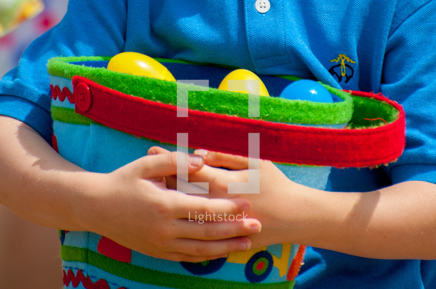 little boy holding an Easter basket