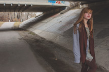 teen girl alone under a bridge 
