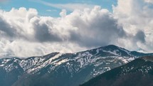Dramatic heavy clouds sky motion over alpine mountains in early spring season Nature time-lapse 

