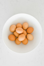 brown eggs in a white bowl 