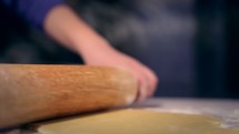 rolling dough with a rolling pin 