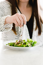 a woman eating a salad 