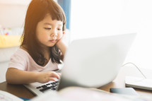a toddler on a laptop computer 
