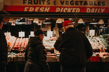 people shopping for produce at a market 