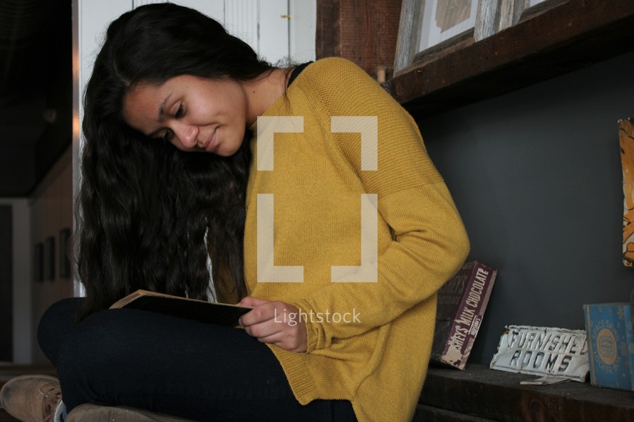 a young woman reading a book 