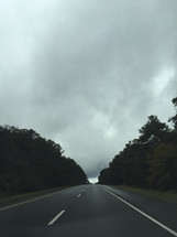gray clouds over a road 
