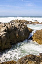 ocean water washing onto a rocky shore 