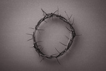 Crown of thorns over grey background. Top view. Copy space. Christian Easter concept. Crucifixion of Jesus Christ. He risen and alive. Jesus is the reason. 