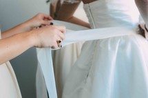 tying a brides dress 