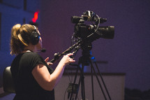 a woman behind a video camera 