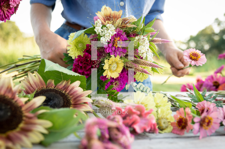 a woman making bouquets of flowers 
