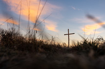 A wooden cross at sunrise.