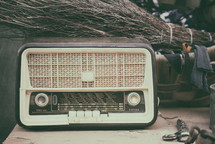 Vintage radio on wood table with various utensils