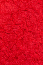 Background surface of wrinkled red and crumpled paper.