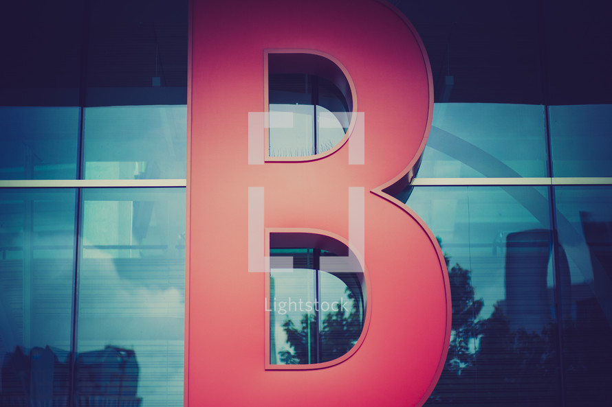 Letter "B" of a neon sign on a building