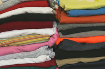 Stacks of folded clothes for boys and girls