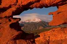 snow capped mountain peak and red rock formation 