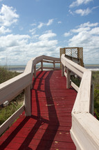 red wood walkway to a beach 