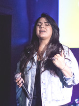 woman singing on stage 
