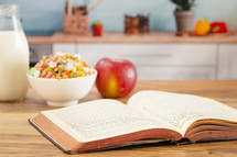 A Bible on a Wooden Table with Breakfast Set a Perfect Way to Start Your Day