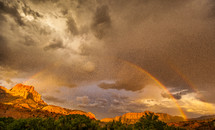 rainbow over red rock canyons 