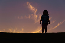 silhouette of a girl child at sunset 