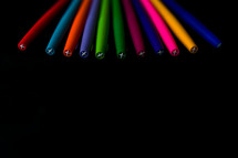 markers on a black background 