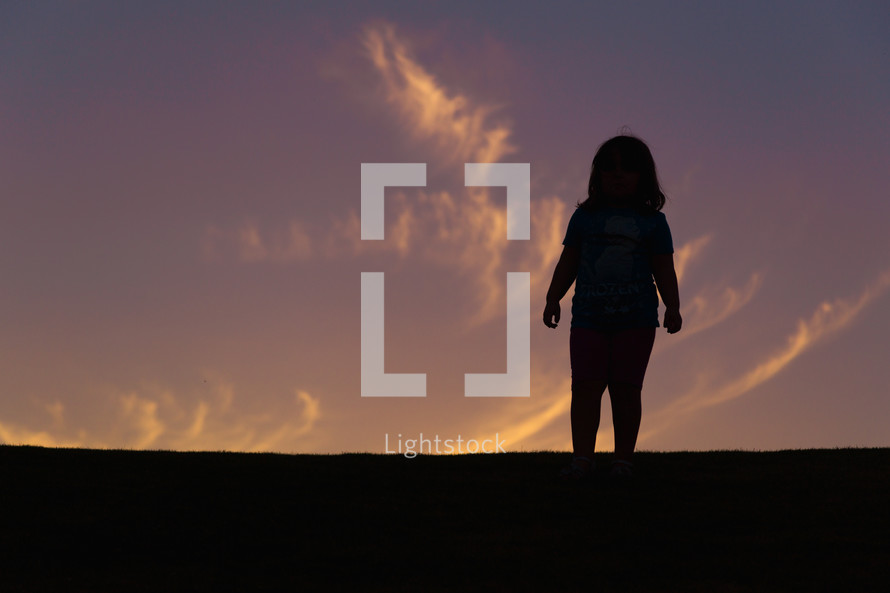 silhouette of a girl child at sunset 
