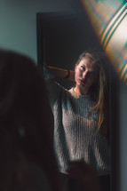 teen girl looking in the mirror 