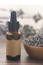 dried lavender and essential oil bottle 