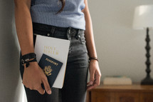 woman holding a Bible and passport 