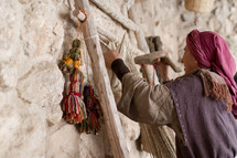 a woman knitting with yarn 