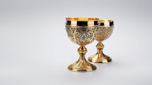 The Holy Grail cups in gold against a white background. 
