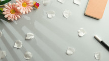 Background with flower petals and a notebook