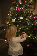 Small child holding a "big sister" ornament