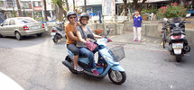 women riding a vespa scooter 