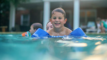 a boy swimming in a pool 