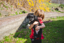 little girl hugging a puppy 