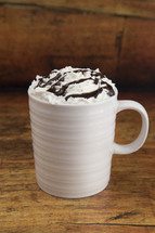 mug with whipped cream and chocolate syrup 