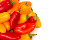 yellow, red, and orange peppers on white 