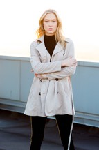 a woman wrapped in a trench coat 
