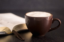 latte and Bible on a slate table 