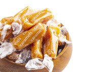 wrapped caramel candies on a white background 