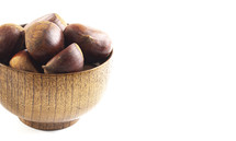 Bowl of hazelnuts on a white background